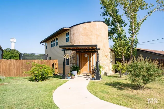 a view of a house with small yard plants and a small yard