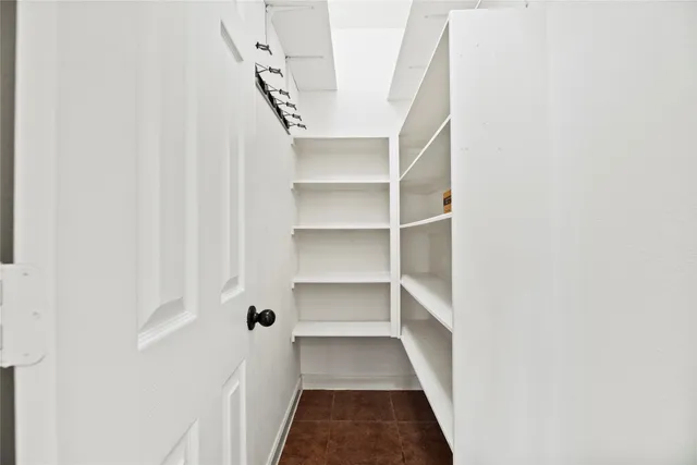 an empty room with windows and ceiling fan