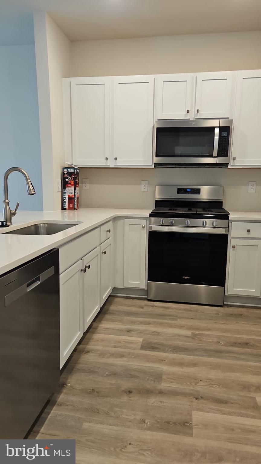 18 Elliot Lane Westampton, NJ 08060 - Photo 12 of 38 a kitchen with stainless steel appliances a stove a sink and white cabinets