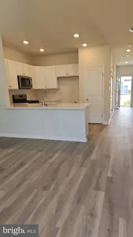 a view of kitchen with stainless steel appliances refrigerator and stove