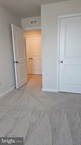 a view of an empty room and closet area