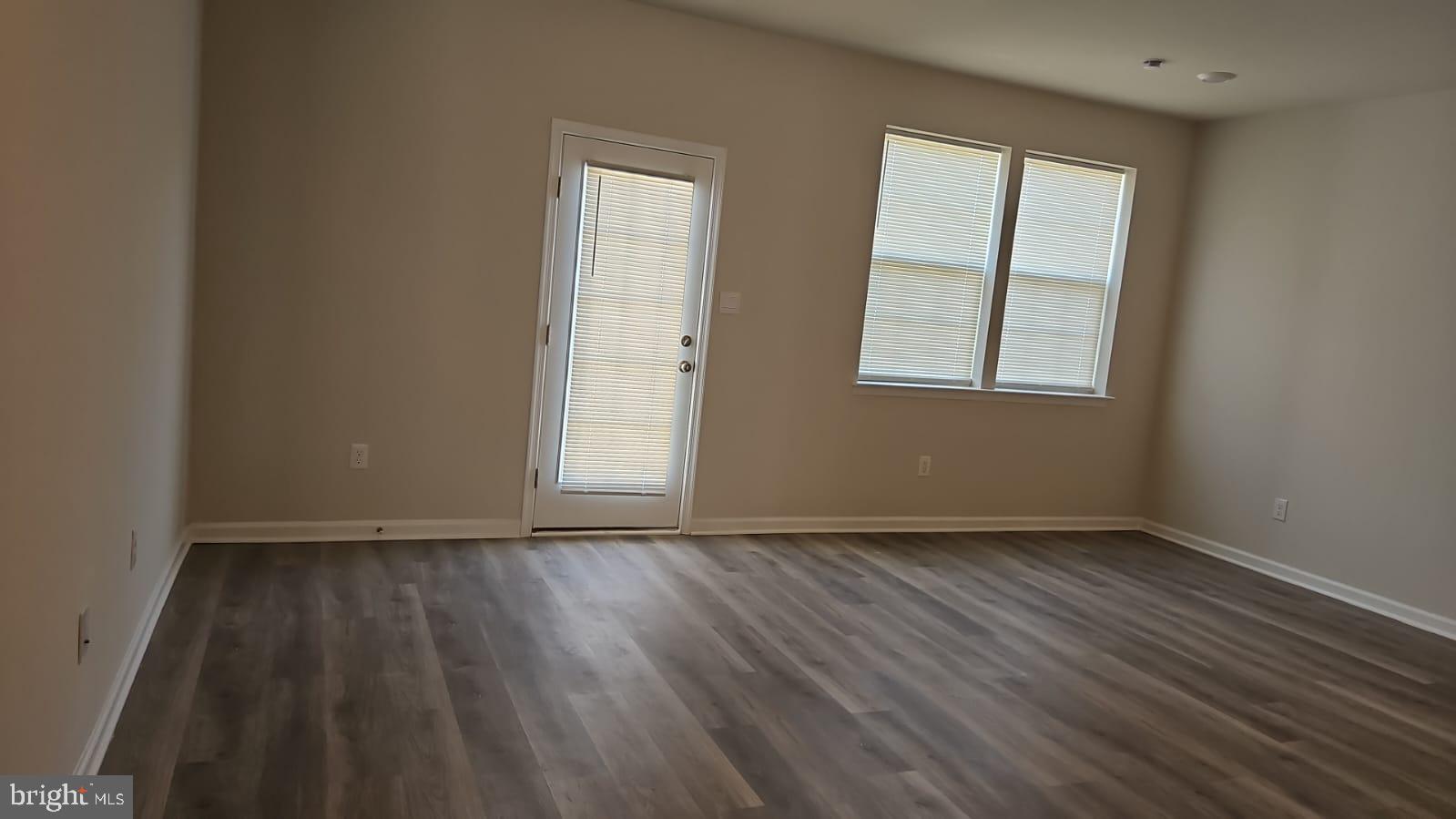 18 Elliot Lane Westampton, NJ 08060 - Photo 7 of 38 an empty room with wooden floor and windows