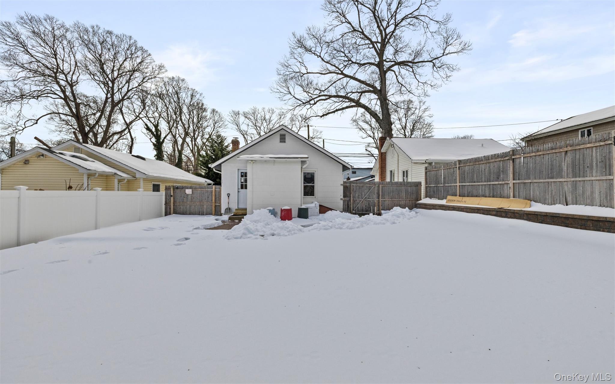 61 Eastview Road Ronkonkoma, NY 11779 - Photo 18 of 27 a view of a house with a snow in the yard