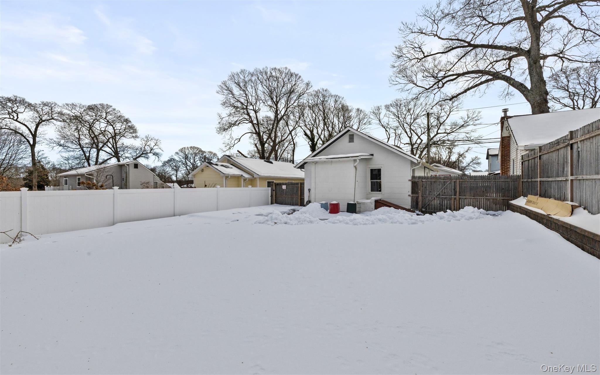 61 Eastview Road Ronkonkoma, NY 11779 - Photo 19 of 27 a view of a house with a snow in the yard