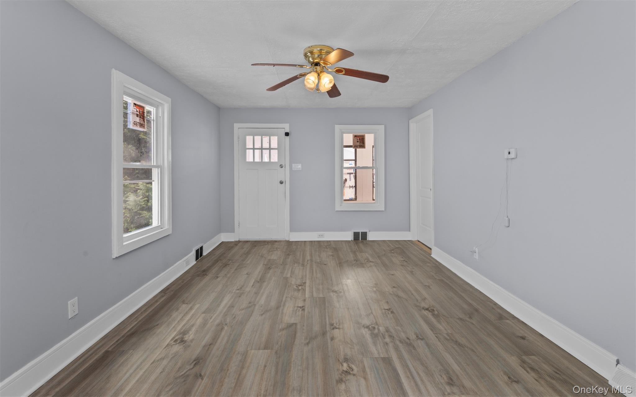 61 Eastview Road Ronkonkoma, NY 11779 - Photo 5 of 27 wooden floor in an empty room with a window