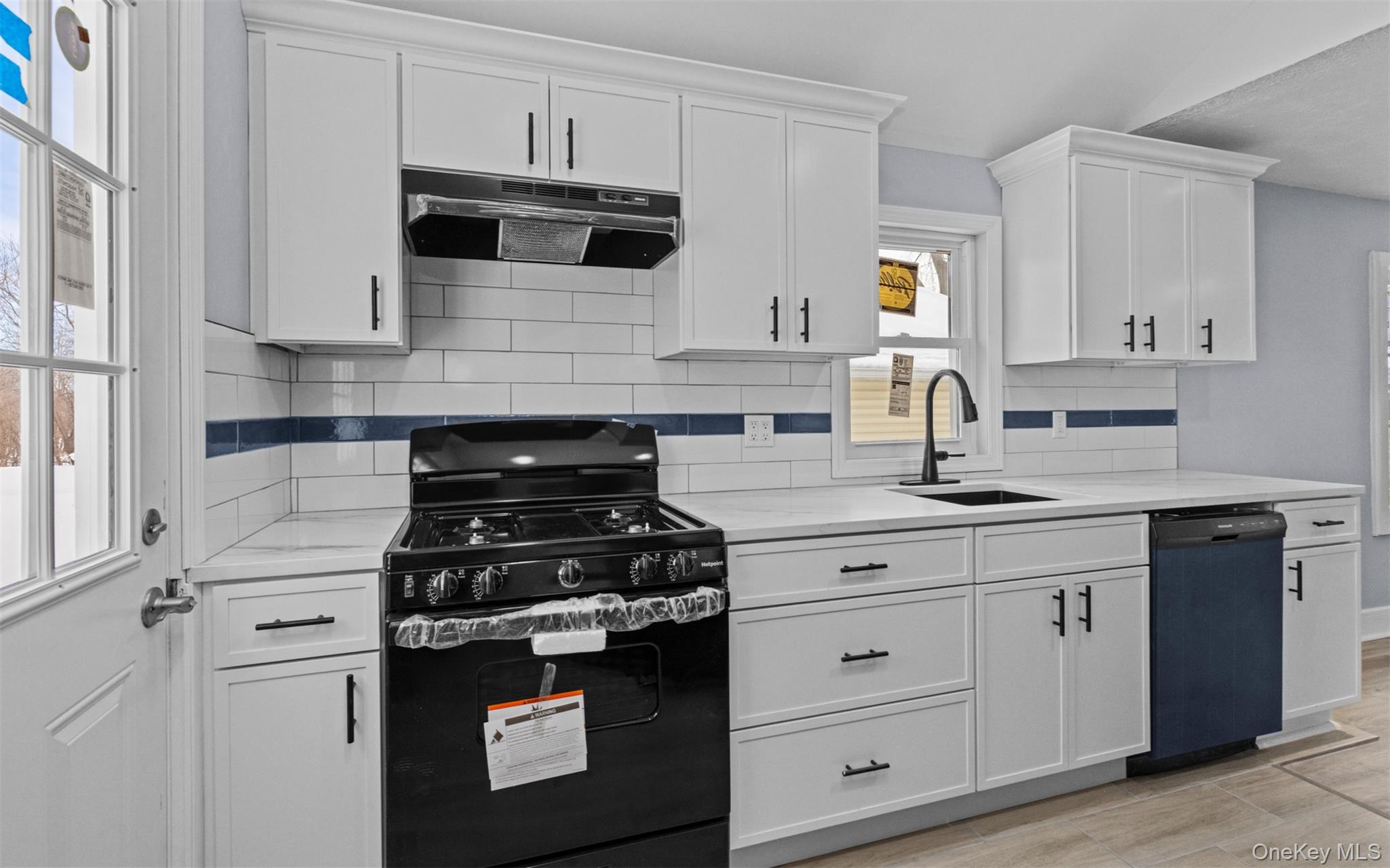 61 Eastview Road Ronkonkoma, NY 11779 - Photo 8 of 27 a kitchen with stainless steel appliances granite countertop white cabinets and stove