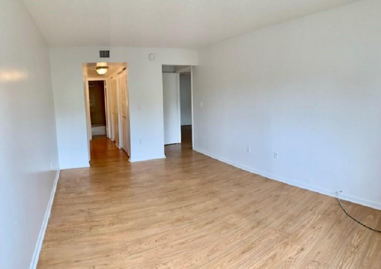 721 North Pine Island Road, Unit 213 Plantation, FL 33324 - Photo 11 of 34 a view of an empty room with wooden floor