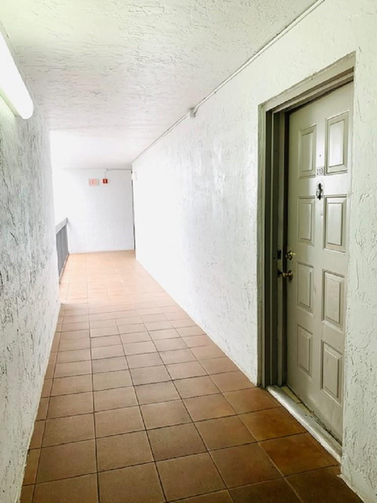 721 North Pine Island Road, Unit 213 Plantation, FL 33324 - Photo 26 of 34 a view of a hallway
