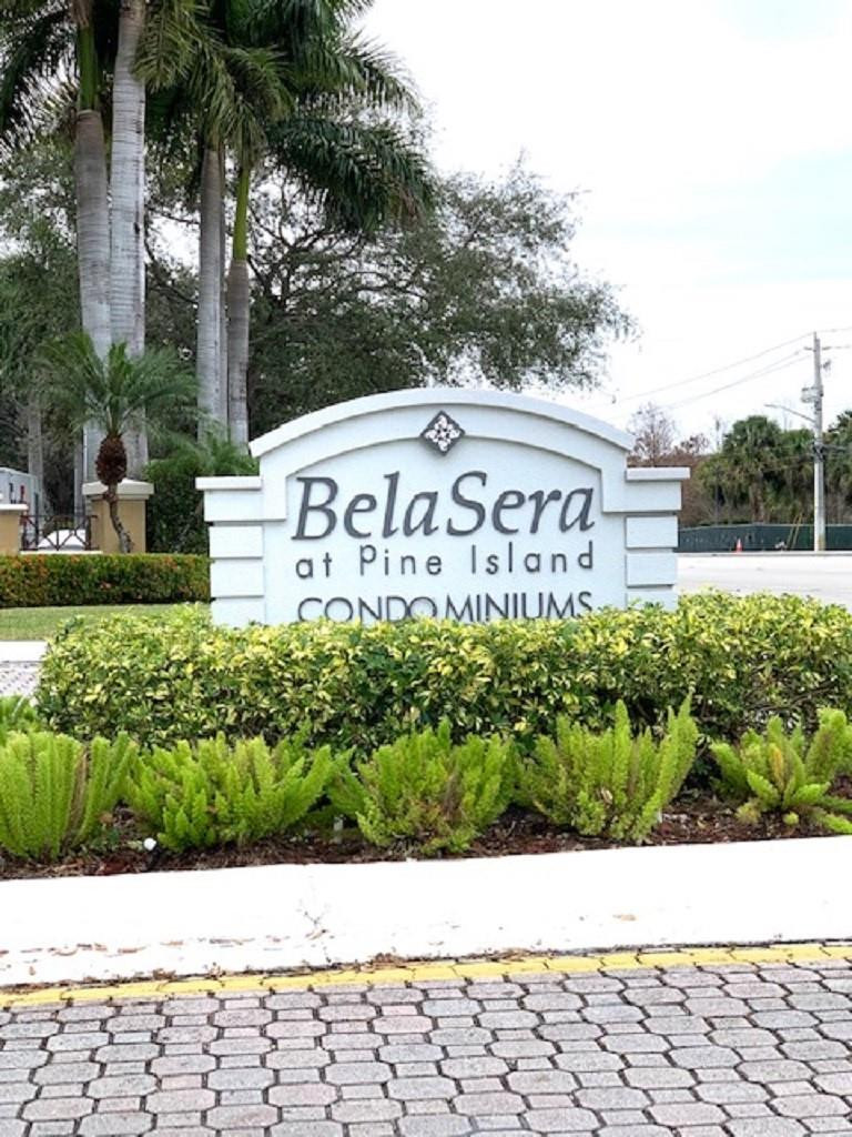 721 North Pine Island Road, Unit 213 Plantation, FL 33324 - Photo 34 of 34 a street sign that is sitting in front of a white house