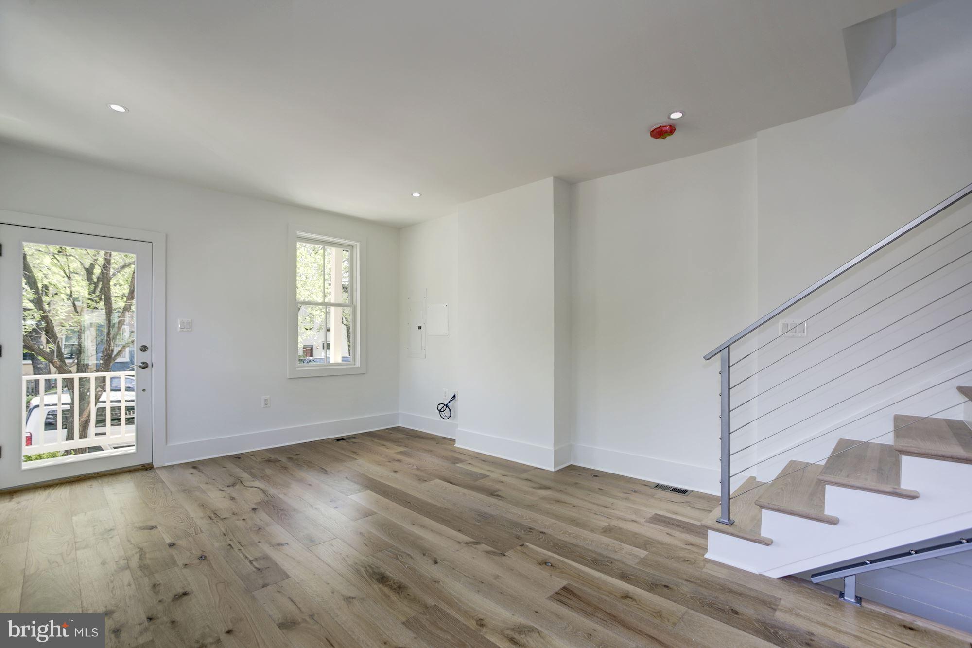 401 11th Street Southeast Washington, DC 20003 - Photo 12 of 27 an empty room with wooden floor and windows