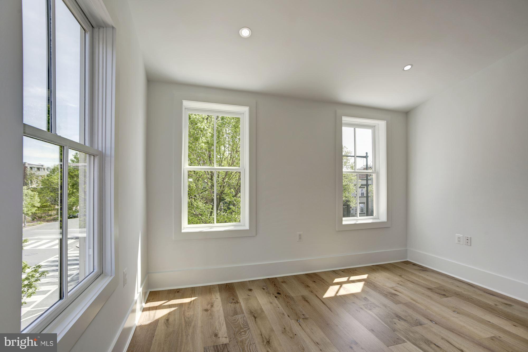 401 11th Street Southeast Washington, DC 20003 - Photo 13 of 27 an empty room with wooden floor and windows