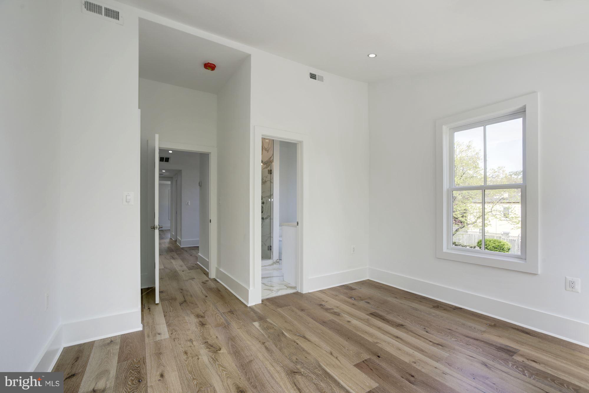 401 11th Street Southeast Washington, DC 20003 - Photo 14 of 27 an empty room with wooden floor and windows