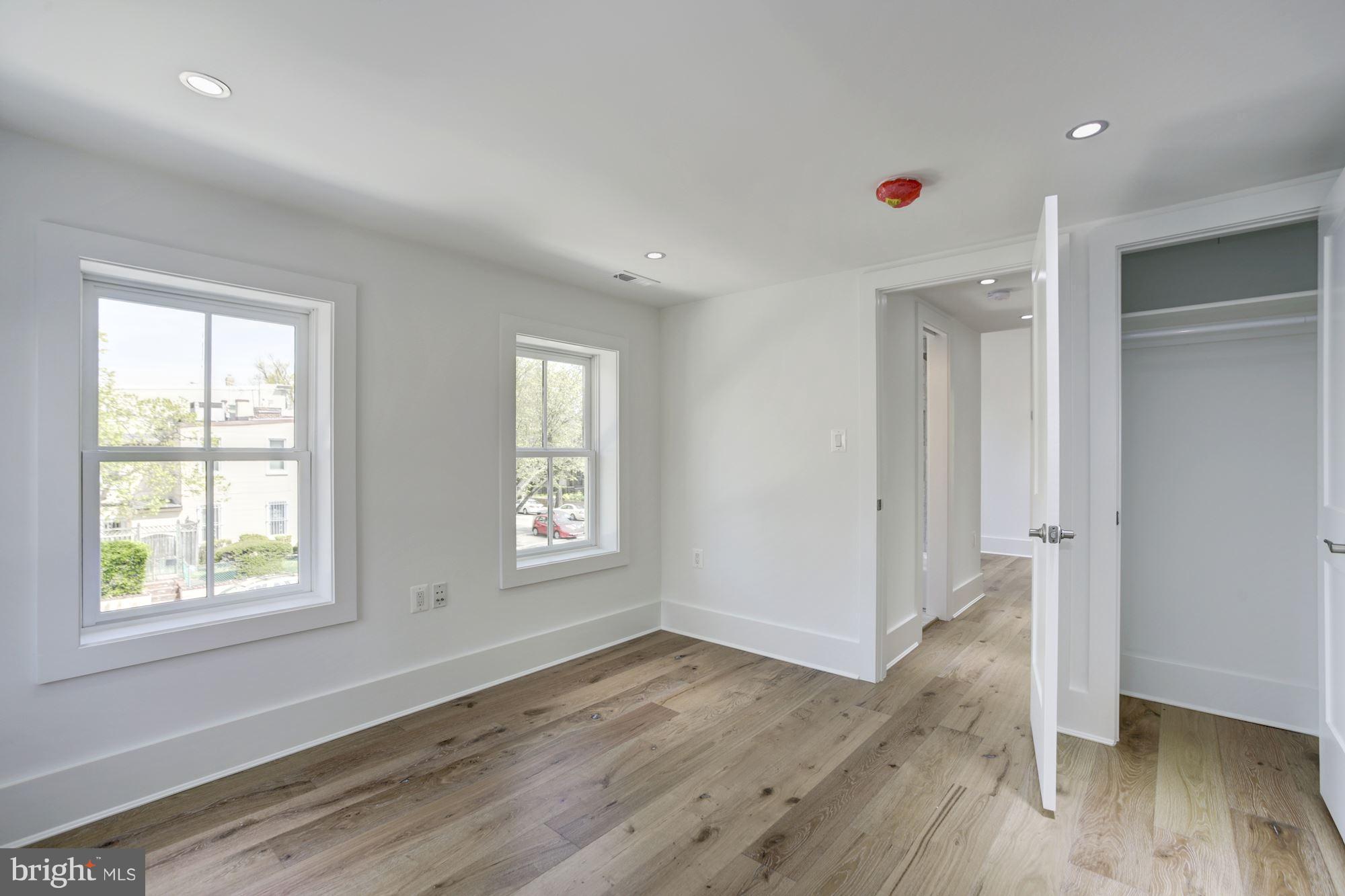 401 11th Street Southeast Washington, DC 20003 - Photo 17 of 27 a view of an empty room with wooden floor and a window