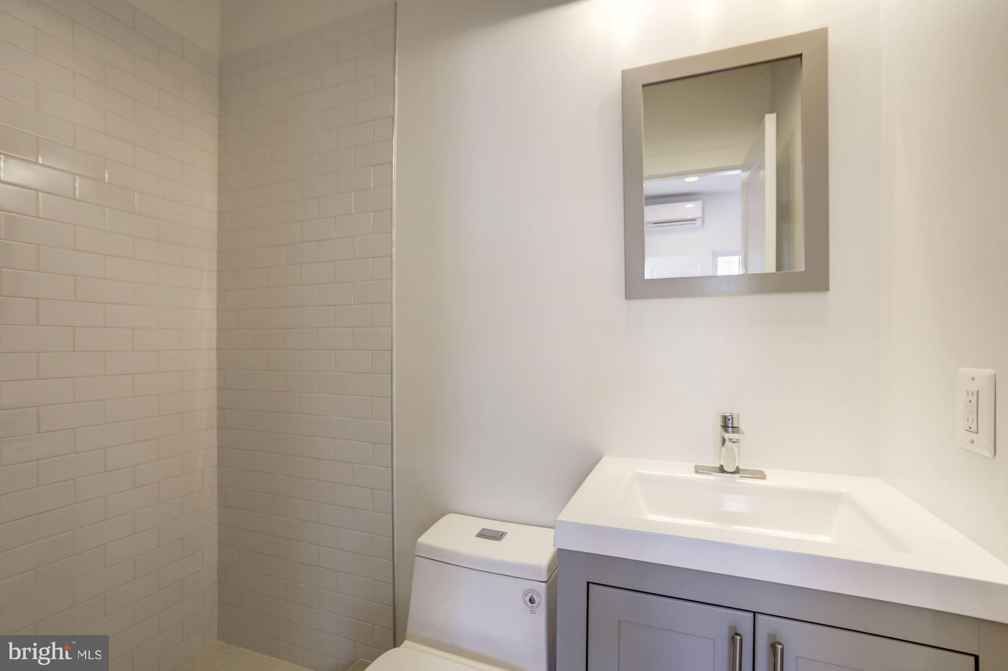 401 11th Street Southeast Washington, DC 20003 - Photo 23 of 27 a bathroom with a toilet sink and mirror