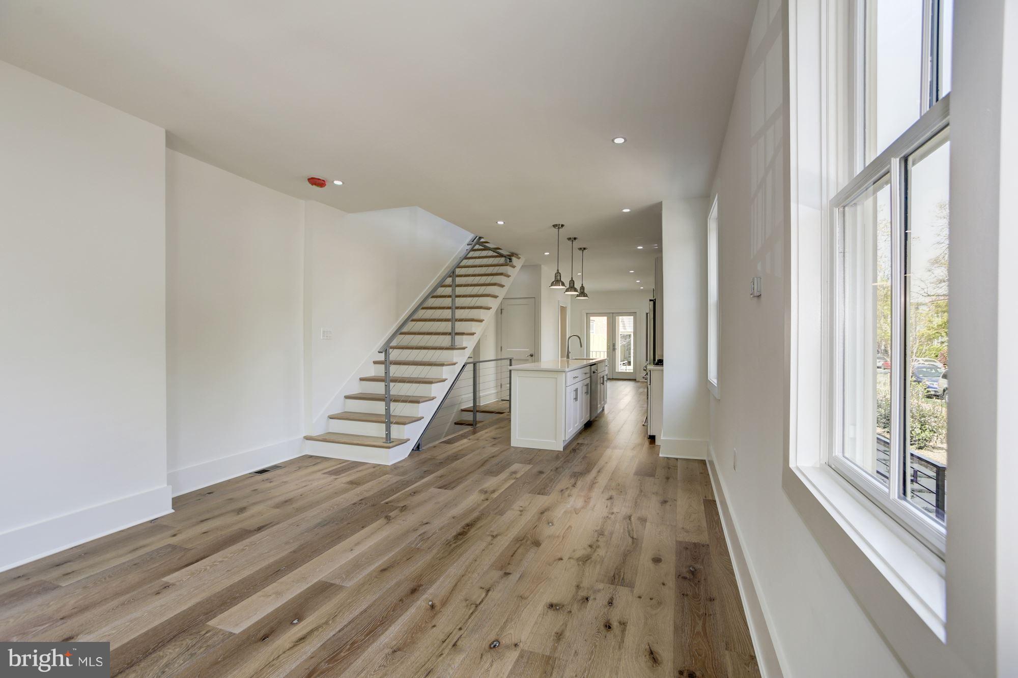 401 11th Street Southeast Washington, DC 20003 - Photo 7 of 27 a view of a hallway with wooden floor and staircase