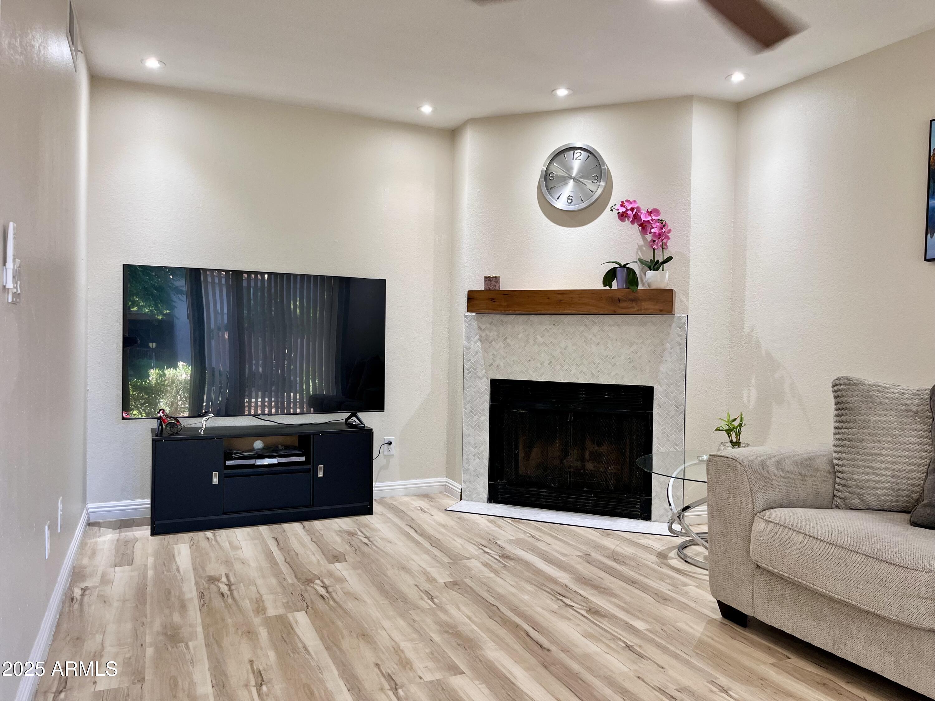 a living room with furniture and a fireplace