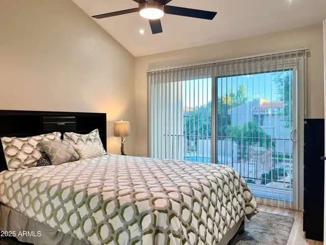 a bedroom with a large bed and a window