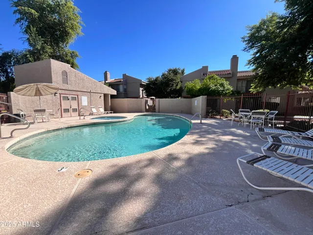 a view of a house with a swimming pool and sitting area