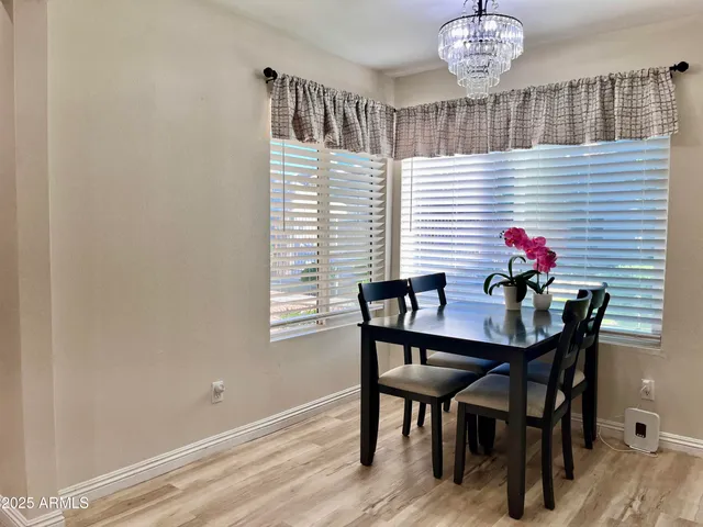 a dining room with furniture and chandelier