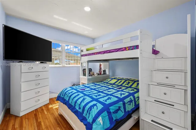 a bedroom with a bed and flat screen tv