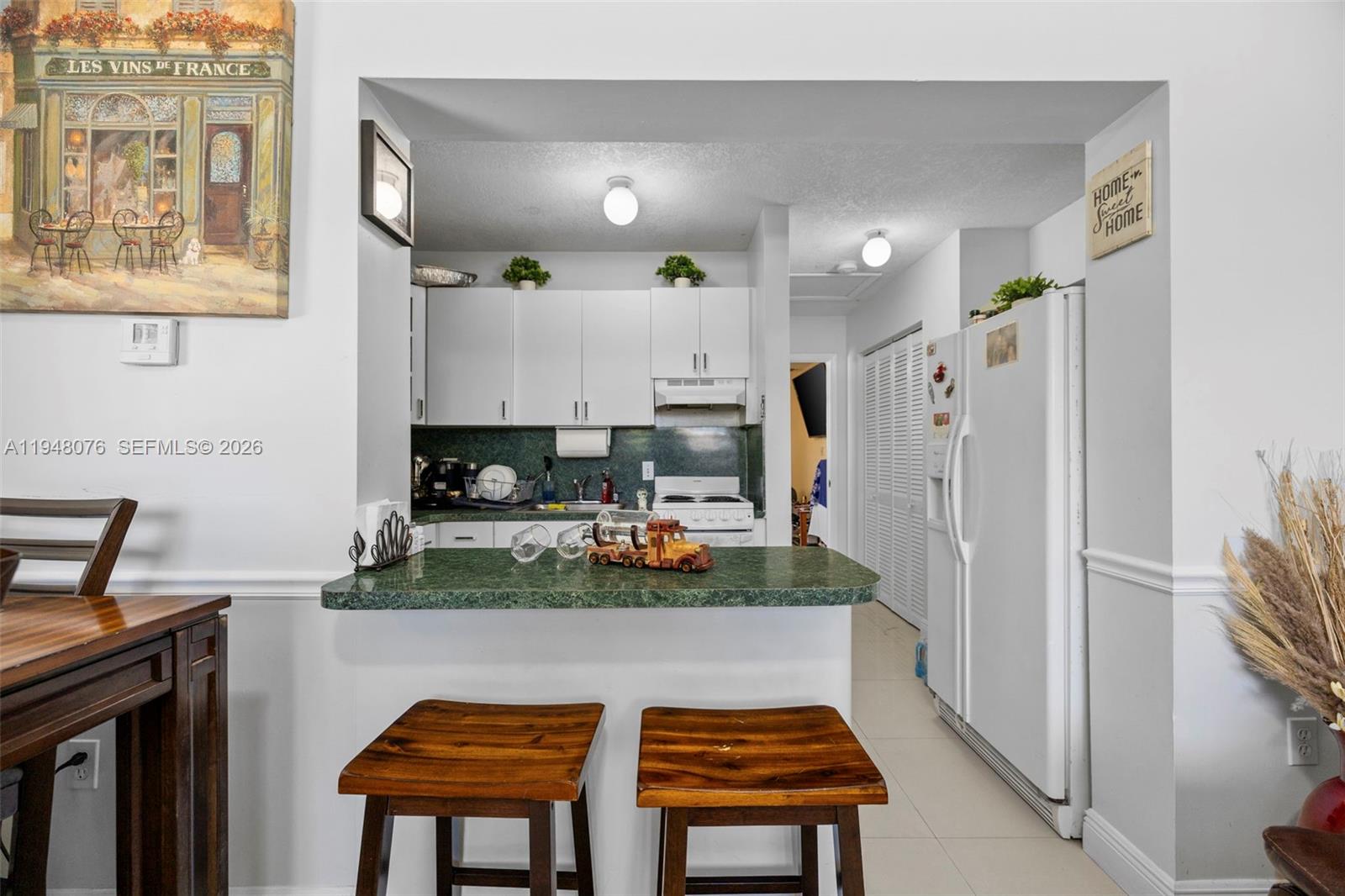 8631 Southwest 16th Terrace Miami, FL 33155 - Photo 34 of 39 a kitchen with stainless steel appliances granite countertop a refrigerator and a stove top oven