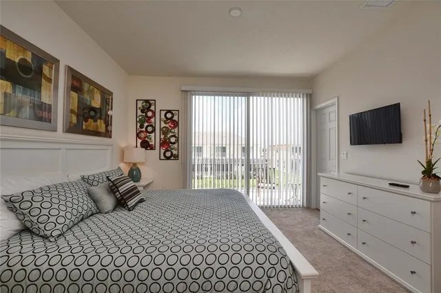 a bed room with a bed a television and a large window