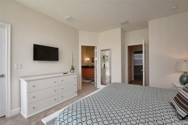 a bedroom with a bed and a flat screen tv