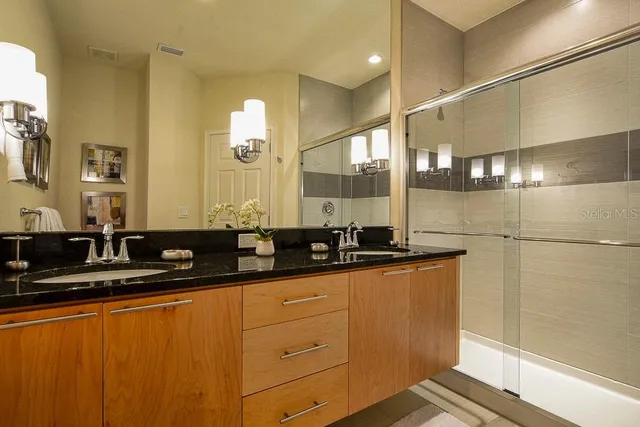 a bathroom with double sink and a mirror