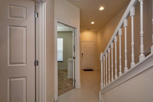 a view of a hallway with wooden floor and entryway