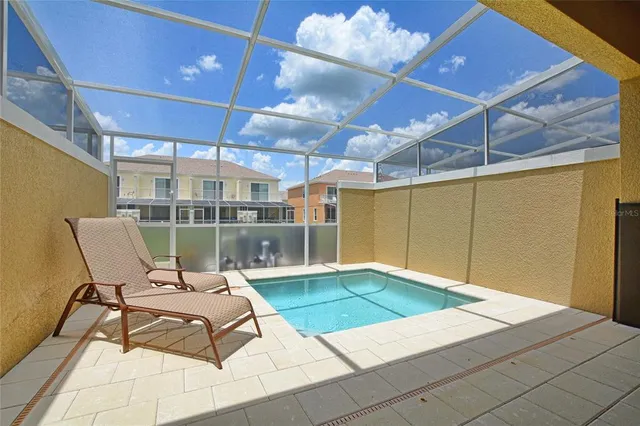 a view of a swimming pool with a lounge chair
