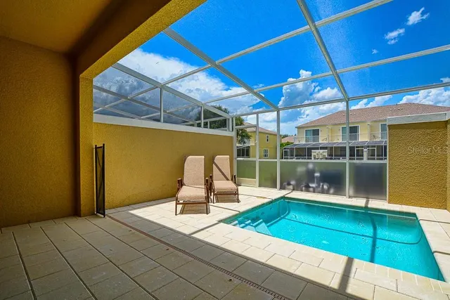 a house with swimming pool in front of it