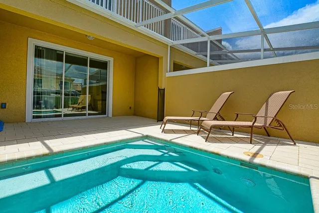 a view of a lake with a big yard and large trees