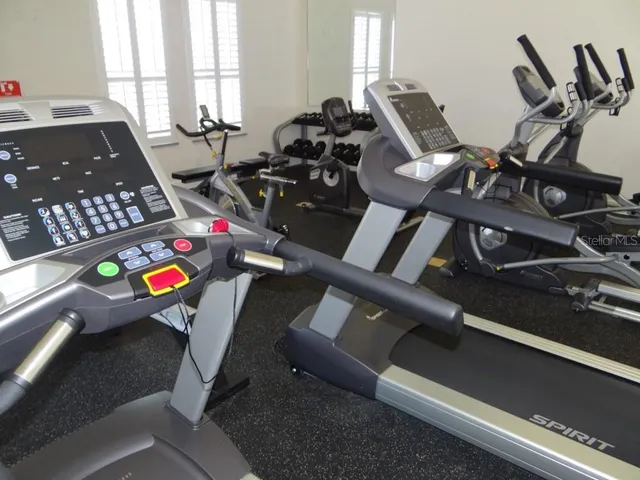 a room with gym equipment and view of living room