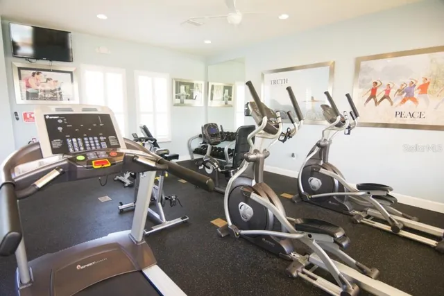 a room with gym equipment and windows