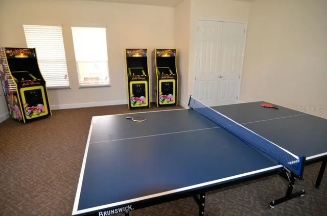 a living room with furniture a flat screen tv and a table