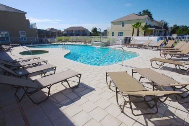 a view of a house with a backyard porch and sitting area