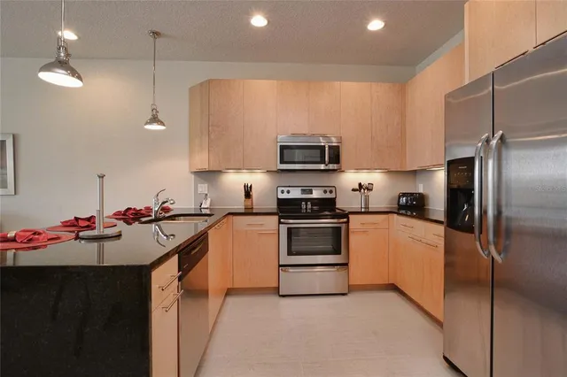 a kitchen with a sink stainless steel appliances and cabinets