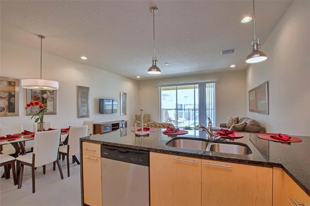a kitchen with sink and living room view