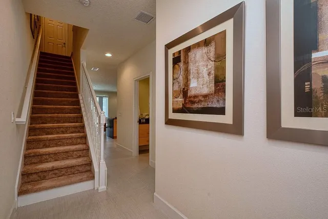 a view of a hallway with paintings on the wall