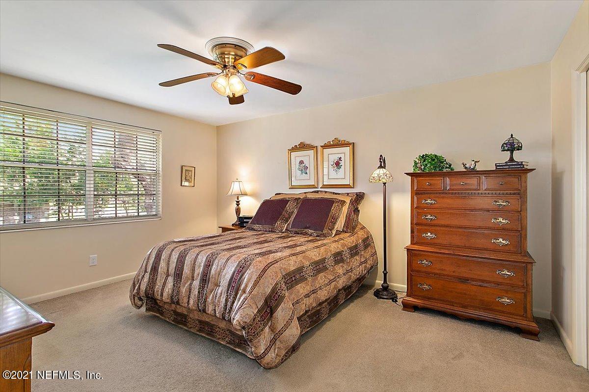 4064 Heath Road Jacksonville, FL 32277 - Photo 13 of 23 a bed room with a bed and a ceiling fan