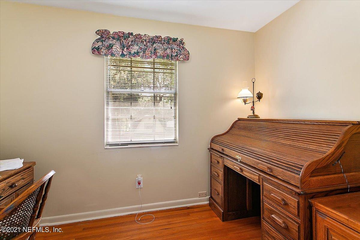 4064 Heath Road Jacksonville, FL 32277 - Photo 19 of 23 a view of an empty room with wooden floor and a window