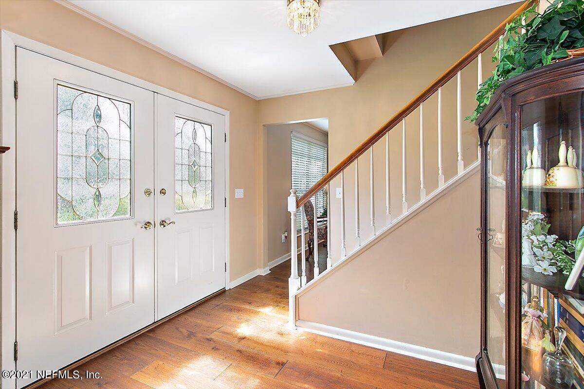 4064 Heath Road Jacksonville, FL 32277 - Photo 3 of 23 a view of entryway with wooden floor and stairs