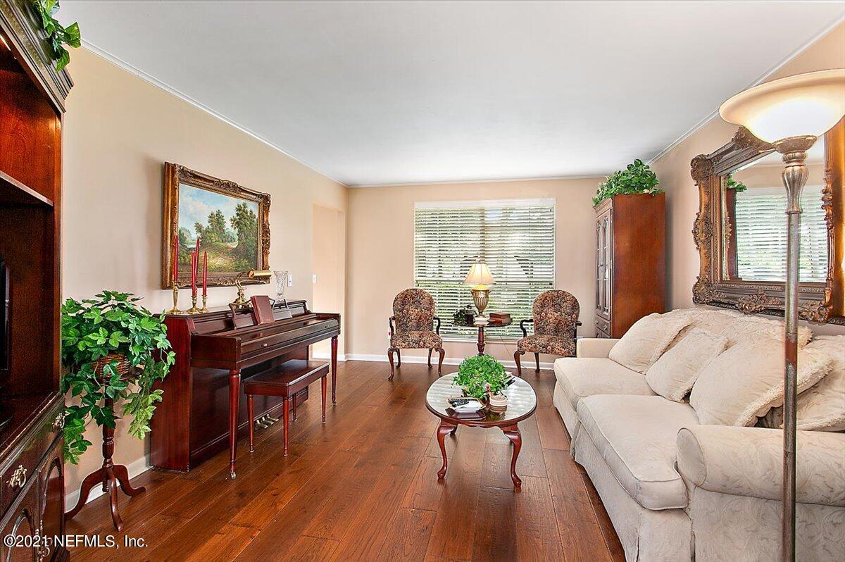 4064 Heath Road Jacksonville, FL 32277 - Photo 4 of 23 a living room with furniture and a wooden floor