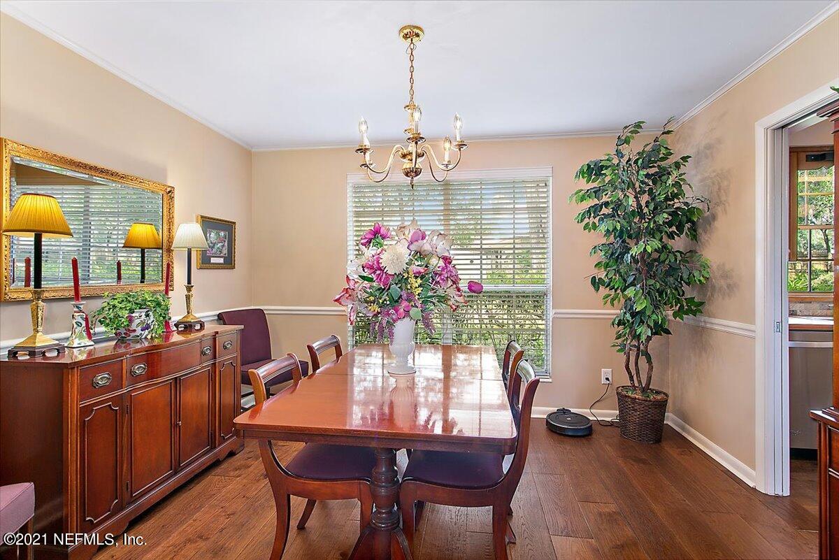 4064 Heath Road Jacksonville, FL 32277 - Photo 5 of 23 a view of a dining room with furniture window and wooden floor