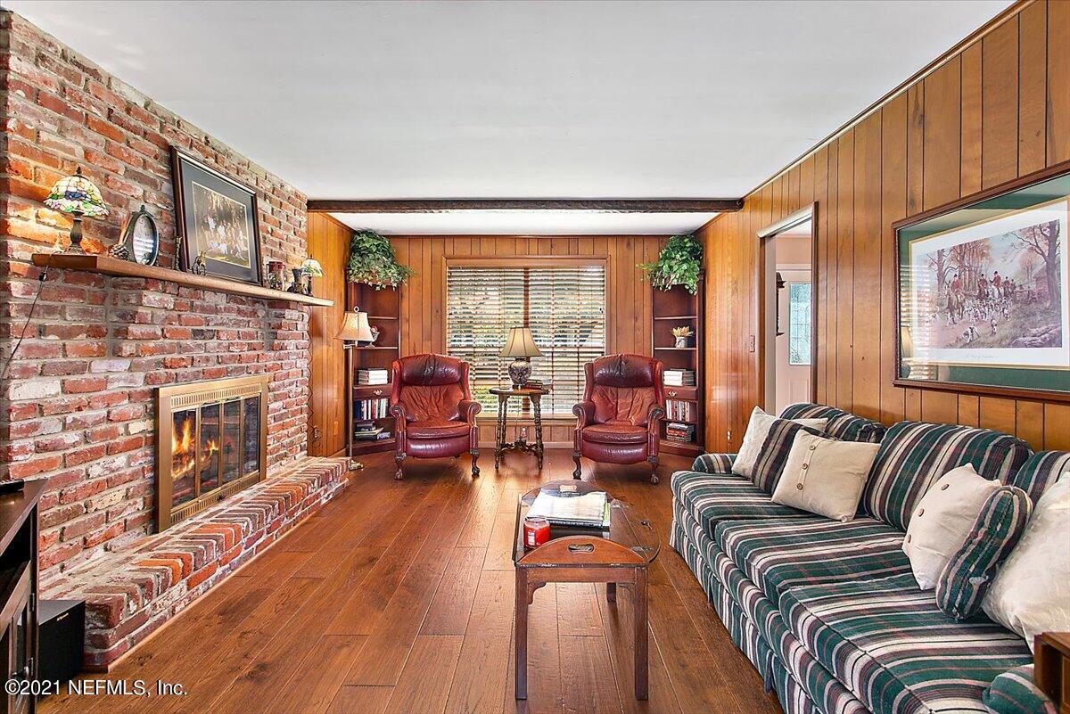 4064 Heath Road Jacksonville, FL 32277 - Photo 6 of 23 a living room with furniture fireplace and a large window