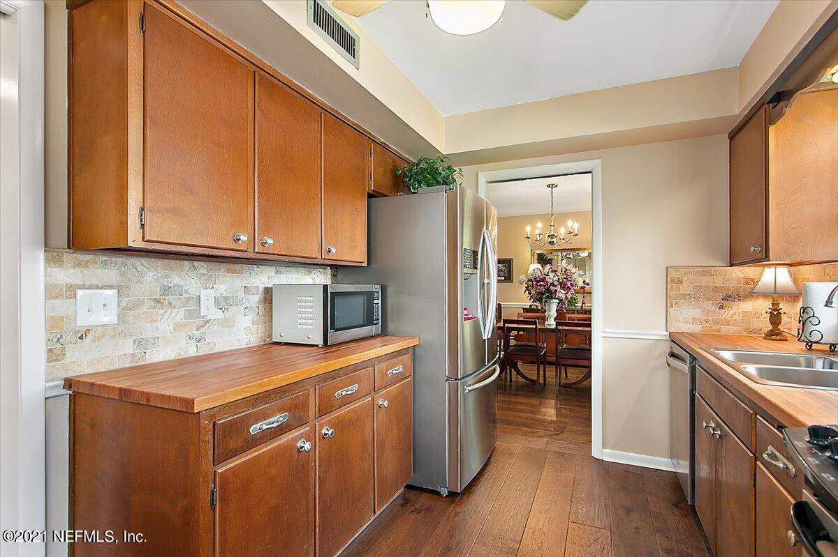 4064 Heath Road Jacksonville, FL 32277 - Photo 9 of 23 a kitchen with a sink stove and cabinets
