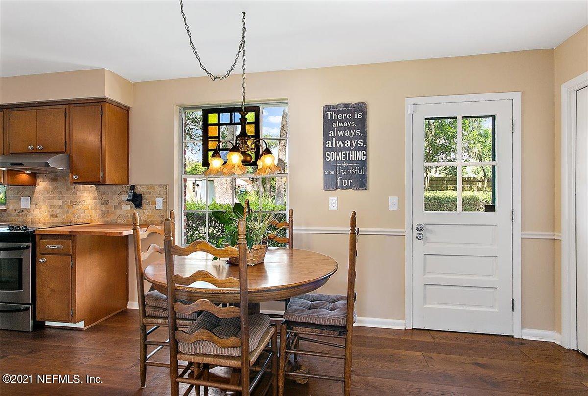 4064 Heath Road Jacksonville, FL 32277 - Photo 10 of 23 a view of a dining room with furniture window and wooden floor