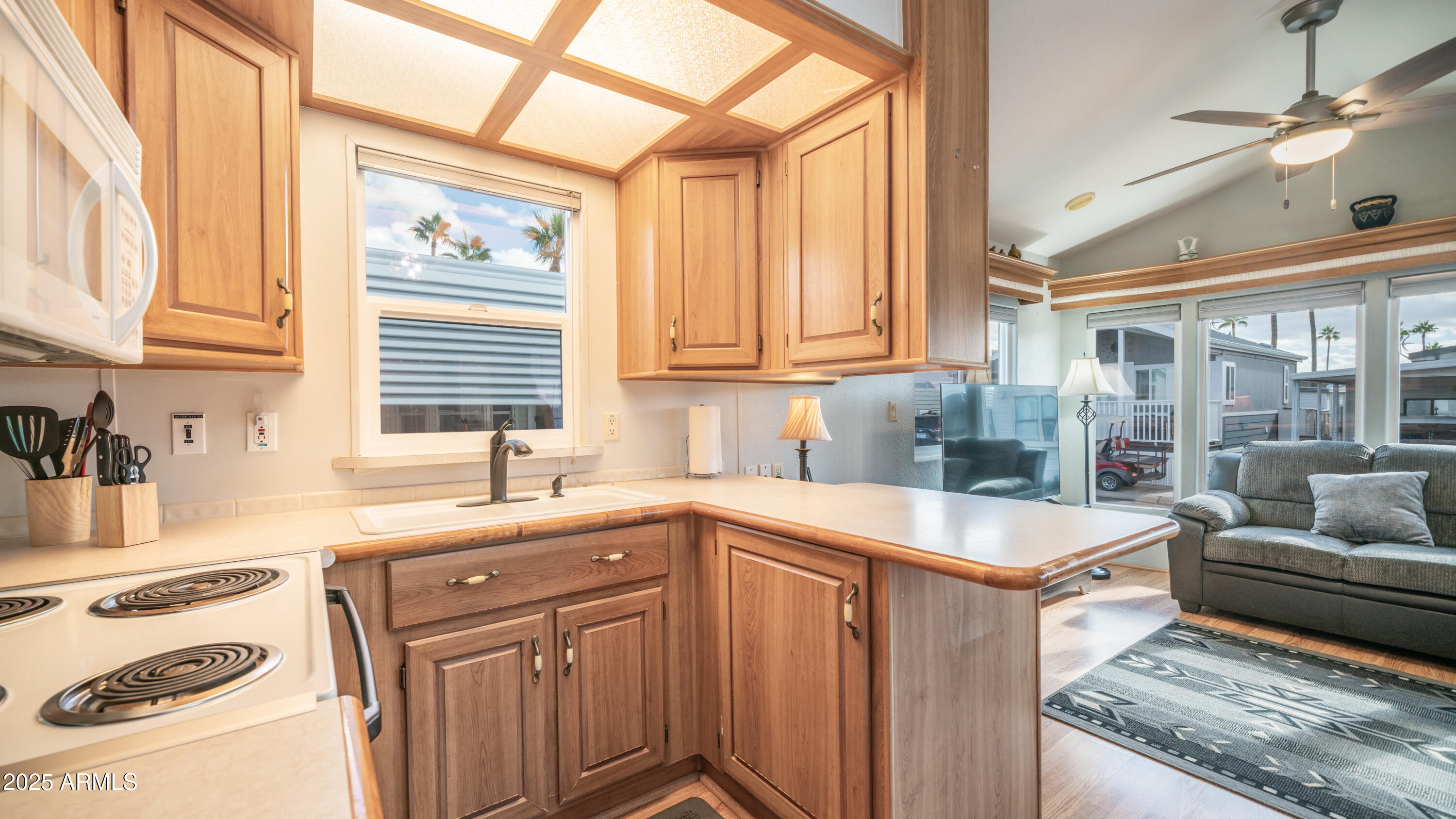 656 Gypsum Drive, Unit 656 Apache Junction, AZ 85119 - Photo 11 of 52 a kitchen with a sink stove and cabinets