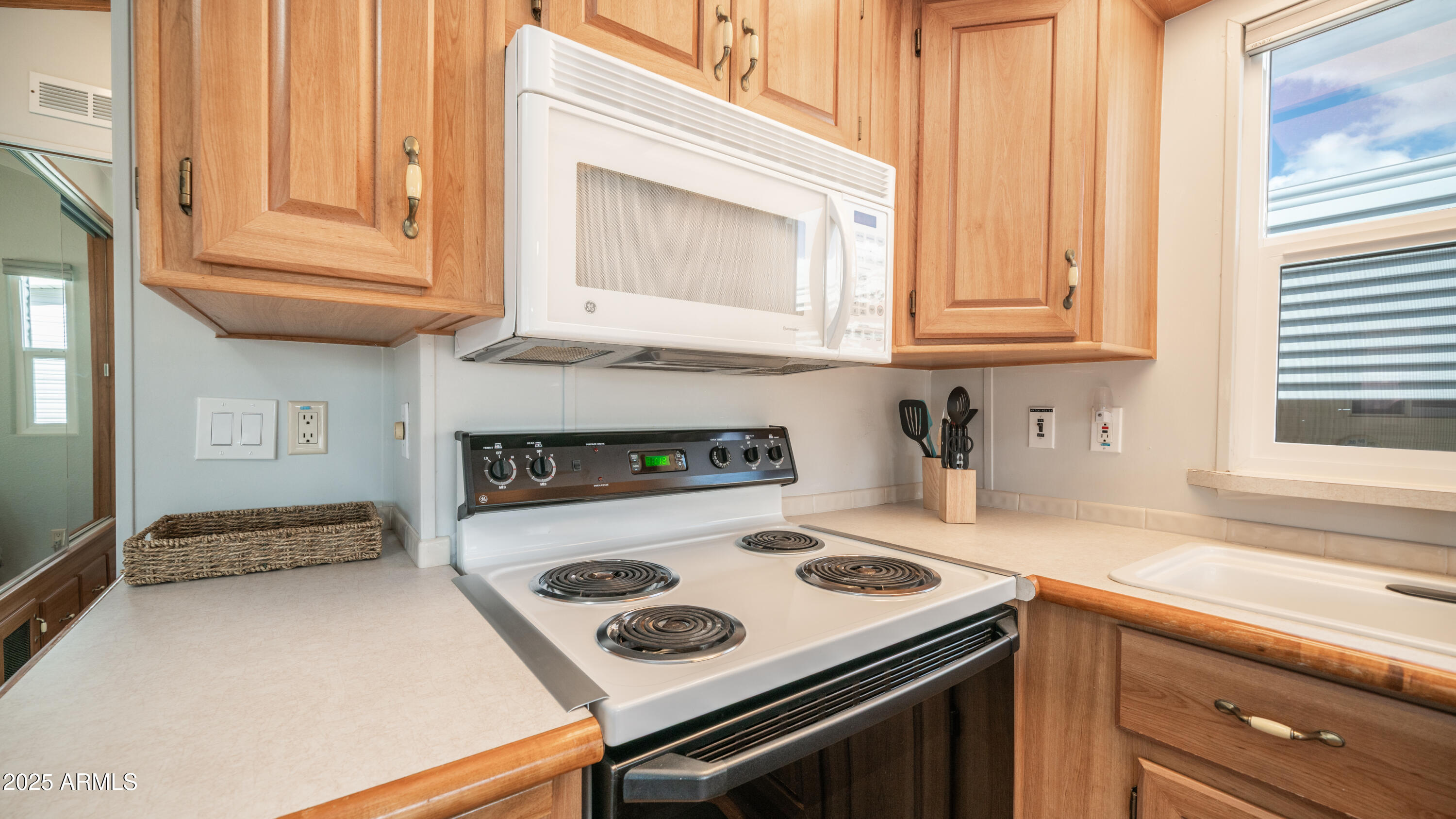 656 Gypsum Drive, Unit 656 Apache Junction, AZ 85119 - Photo 12 of 52 a kitchen with granite countertop a stove and a sink