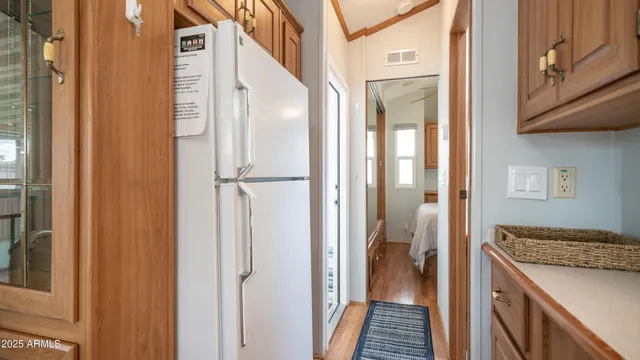 a kitchen with a refrigerator and a sink
